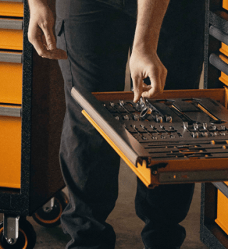 Male mechanic grabbing tools out of his MEGAMOD1024 master mechanics tool set