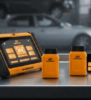 GEARWRENCH SMART Diagnostics line up on top of a stainless steel rolling tool cabinet within an auto shop