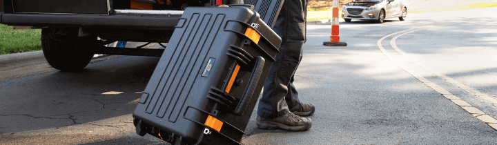 GEARWRENCH portable rolling case being taken to a car for roadside assistance