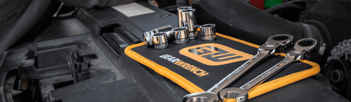 GEARWRENCH magnetic tool mat holding sockets and ratchets during an engine repair