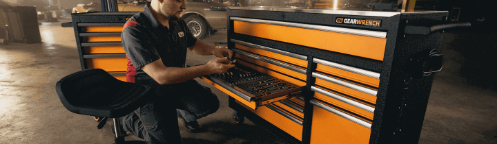 Man reaching for tools out of his MEGAMOD tool set in a professional garage