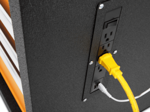 Close-up image of a plugged cord and USB cord plugged into the power strip on a GEARWRENCH rolling cabinet