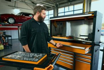 Male mechanic getting tools out of the MEGAMOD1331 storage.