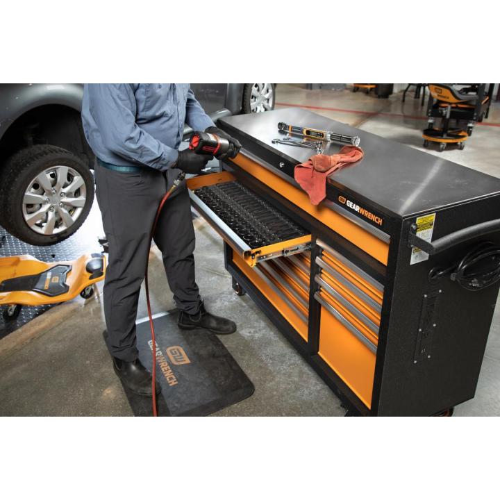 Image of the GEARWRENCH 83247 52" Rolling Tool Cabinet in a garage setting with a person using one of the tools from the open drawer