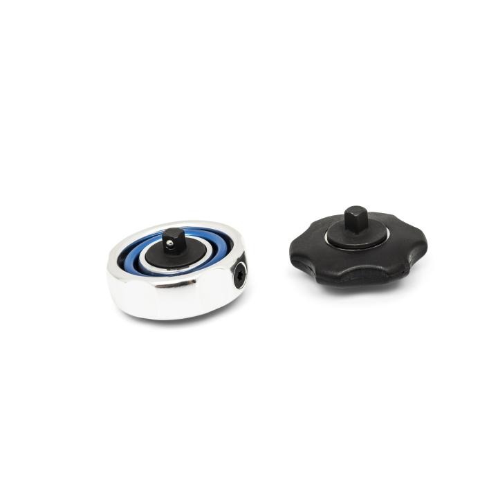 Two low-profile gimbal ratchets sit side by side on white background: one is a silver circular ratchet with a blue ring , and the other is a black  ratchet.