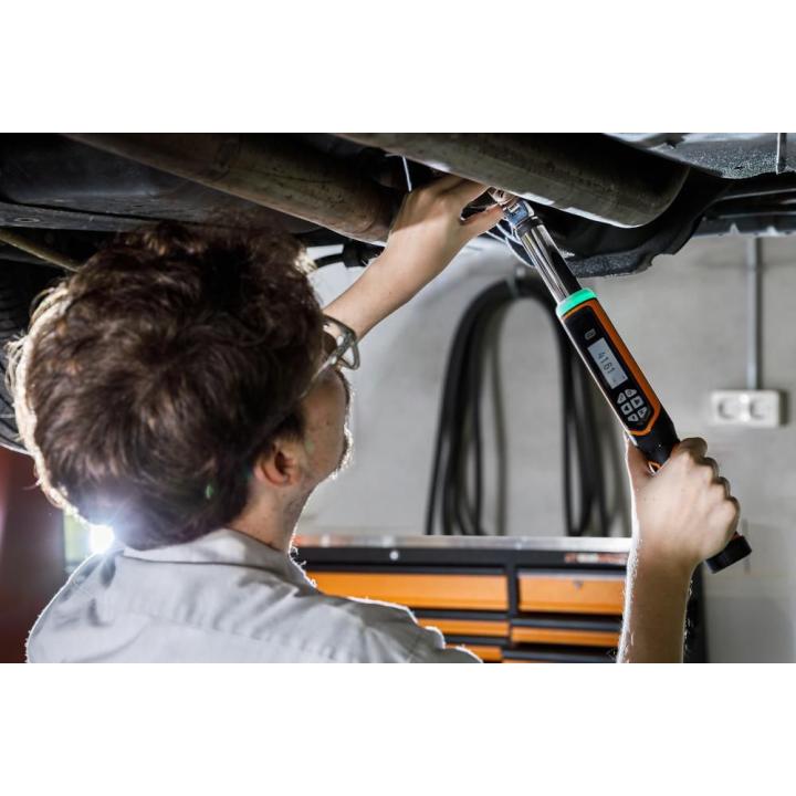 Person using a GEARWRENCH Torque Wrench under a car in a work shop