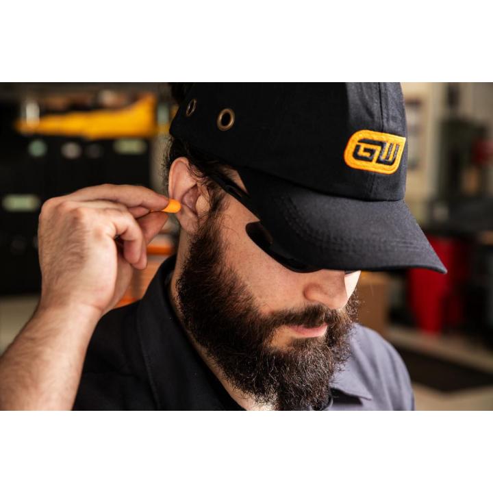 Image of the  Disposable Foam Ear Plugs - 50 Pairs with a person inserting one of the orange ear plugs into an ear