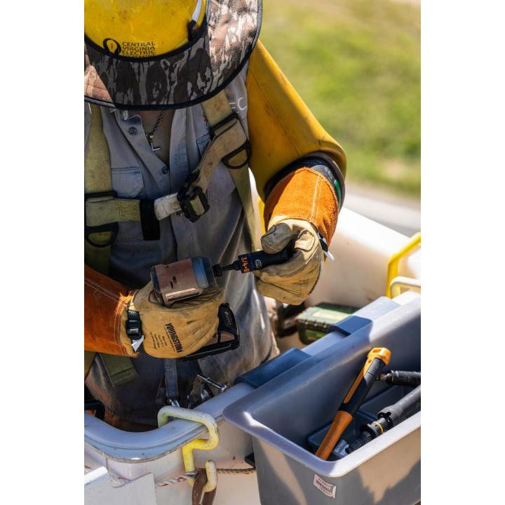 Utility worker holding a GEARWRENCH 3-in-1 lineman slotted deep impact socket while preparing outdoor utility hardware.
