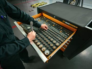 Mechanic getting a GEARWRENCH ratchet and sockets out of his modular foam set in his mobile workstation 