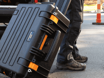 GEARWRENCH portable rolling case being taken to a car for roadside assistance