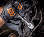 Mechanic wearing black GEARWRENCH gloves using a chrome 120XP ratchet to tighten a fastener