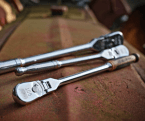 3 GEARWRENCH 90T ratchets sitting on red metal surface