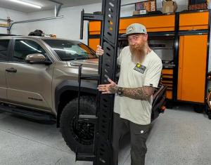Murray Kruger demonstrates a vehicle accessory component in a workshop alongside a customized pickup truck and GEARWRENCH tool storage solutions.